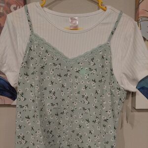 Sheer green and white green lace covered white tee shirt